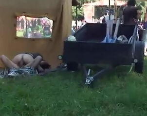 Exhibitionist pair romping near trading tent at honest
